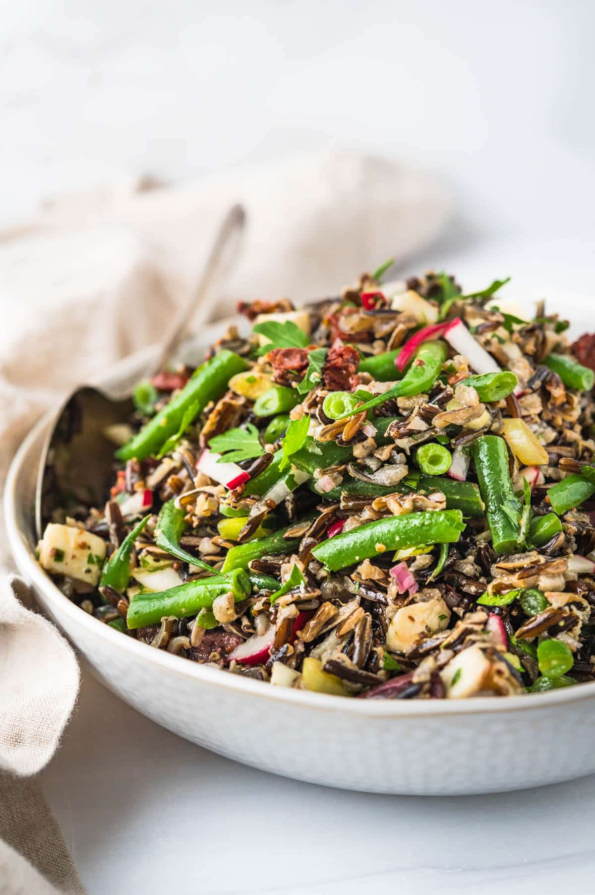 Italian wild rice salad in a white bowl.