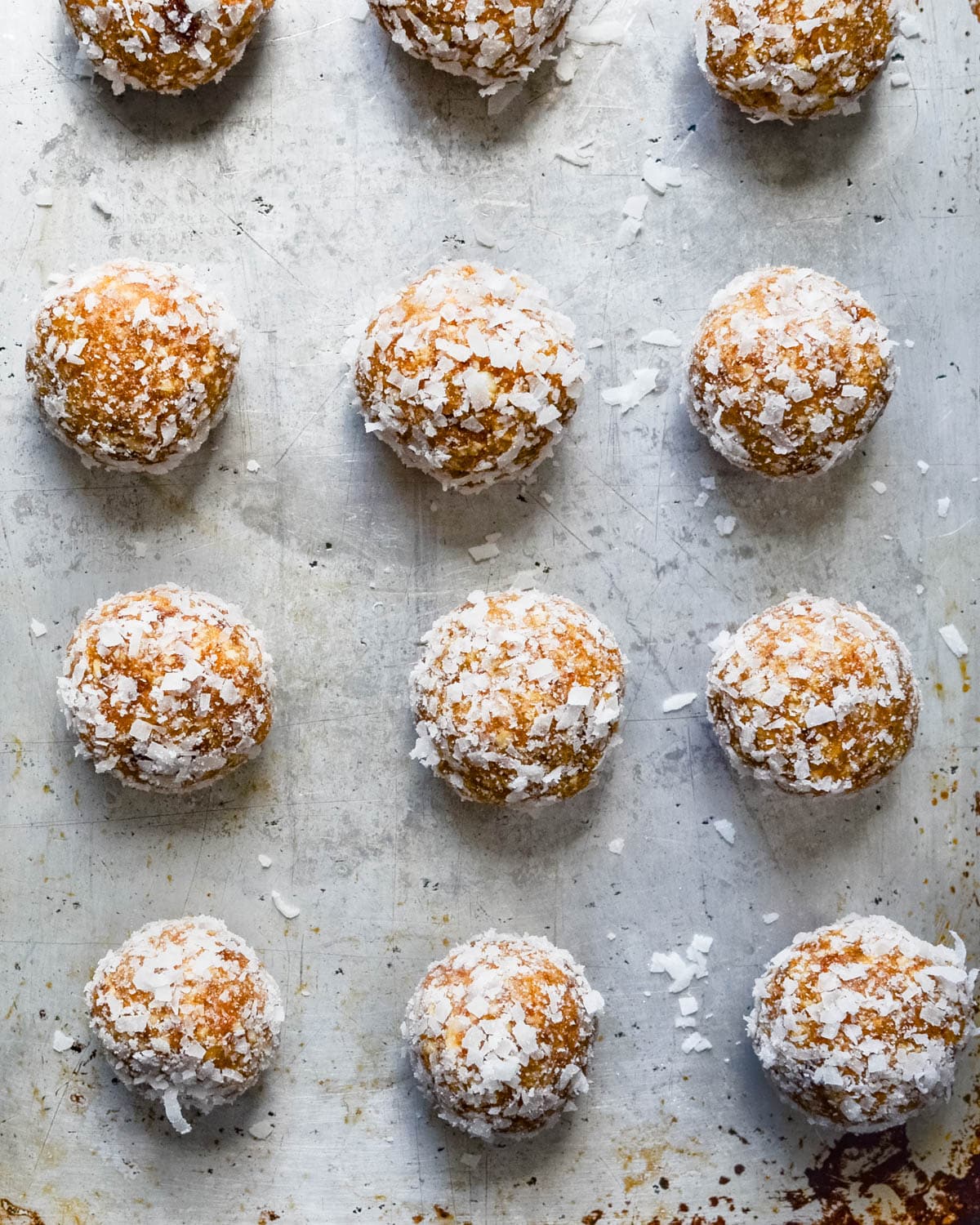 Coating the date nut balls with coconut.