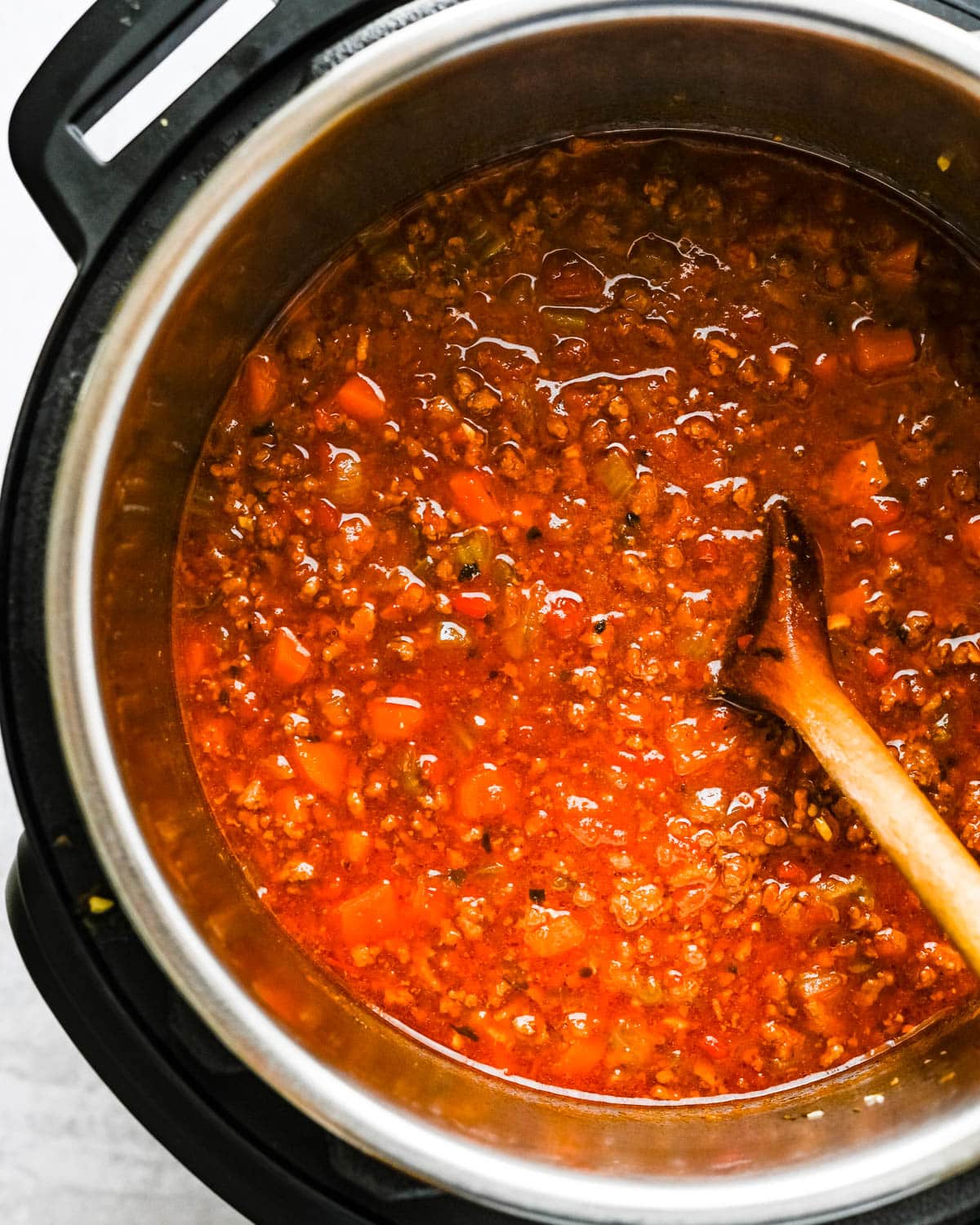 After pressure cooking, the ragu must simmer to evaporate some liquid.
