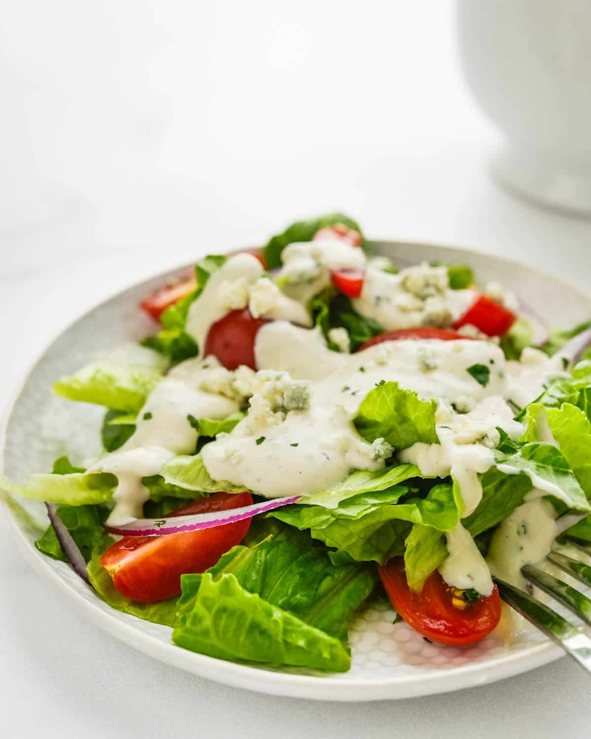 A green salad with blue cheese dressing.