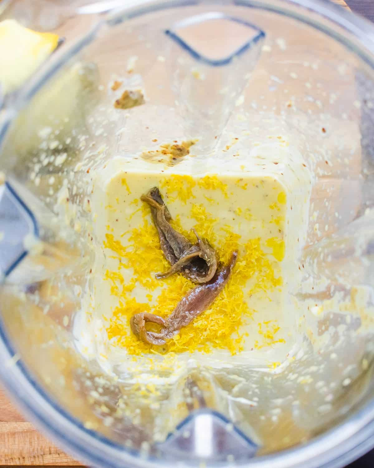 Season the dressing with anchovies and lemon zest.