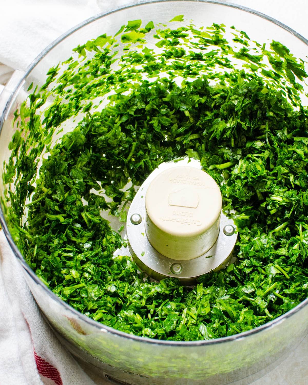 chopping the parsley and cilantro in a food processor.