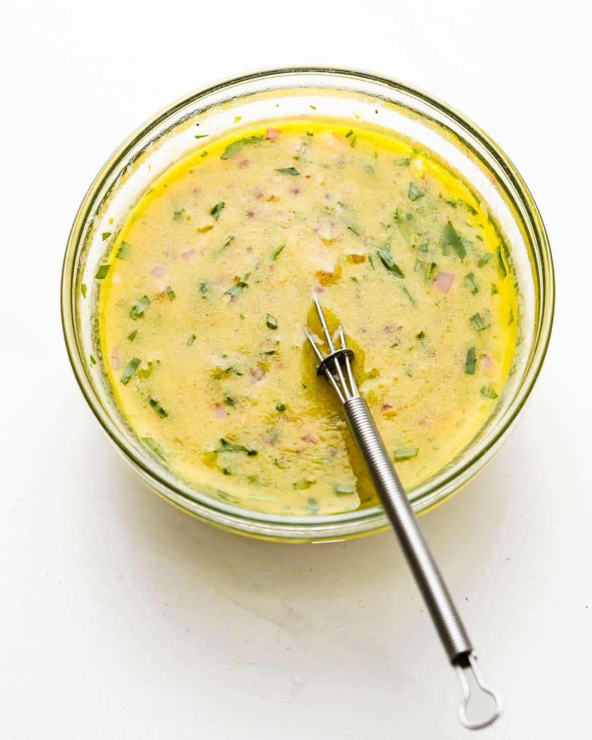 Whisk the dressing until it's creamy and emulsified. 