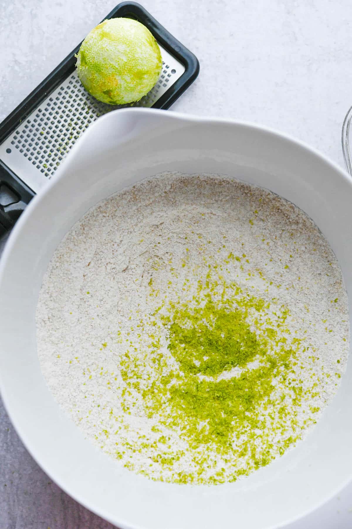 Mixing lime zest with the dry ingredients. 