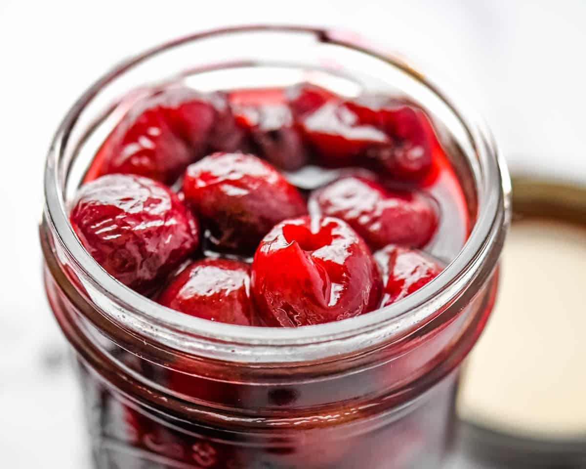 A closeup image of the pickled fruit in a jar.