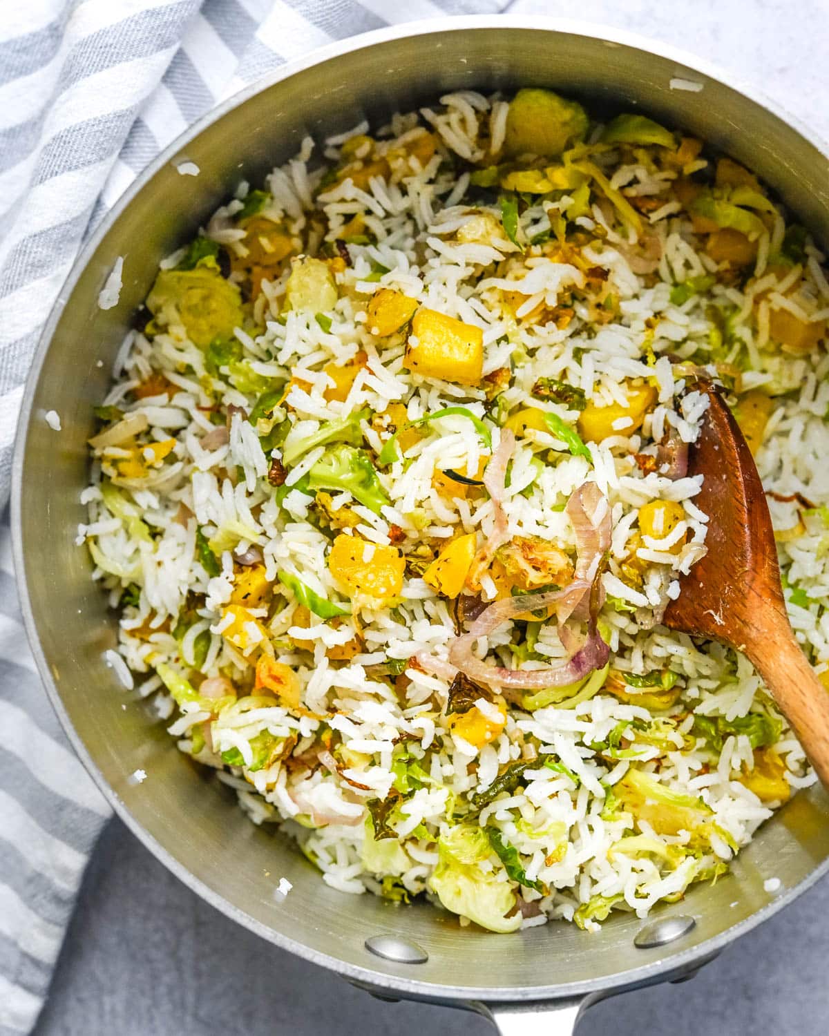 mixing the vegetables with the rice.