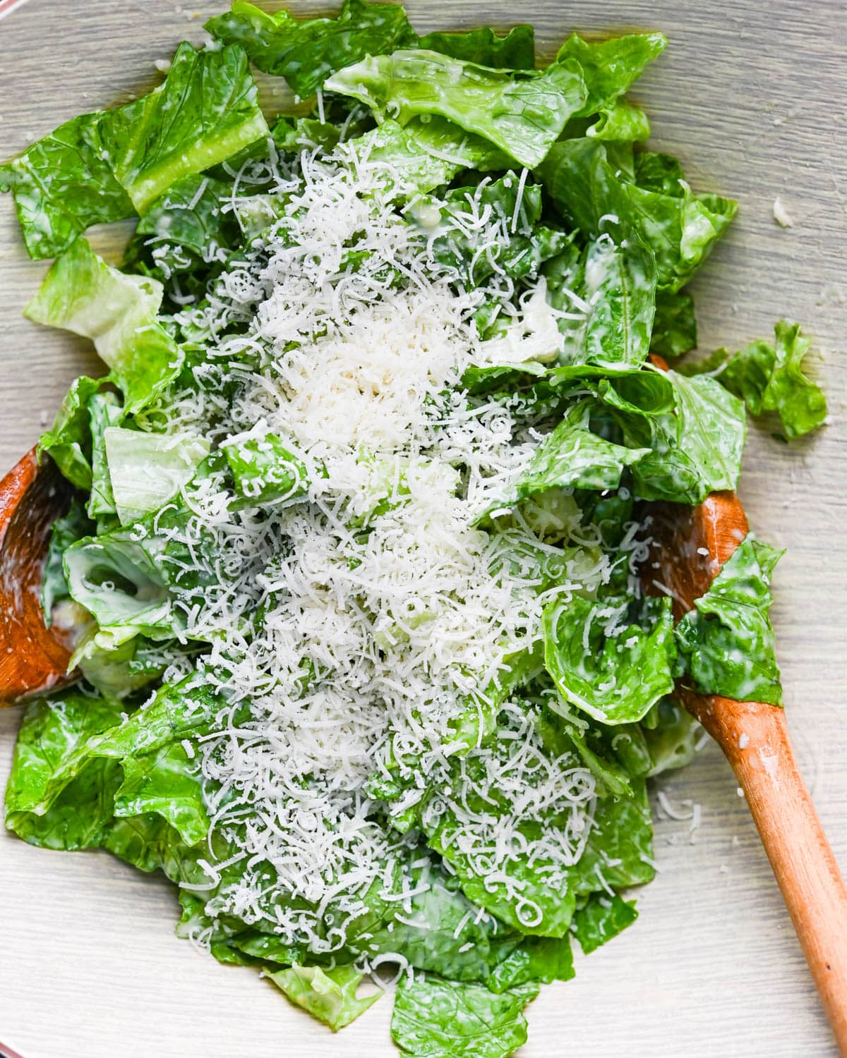 I am mixing the romaine lettuce with salad dressing and extra parmesan cheese. 