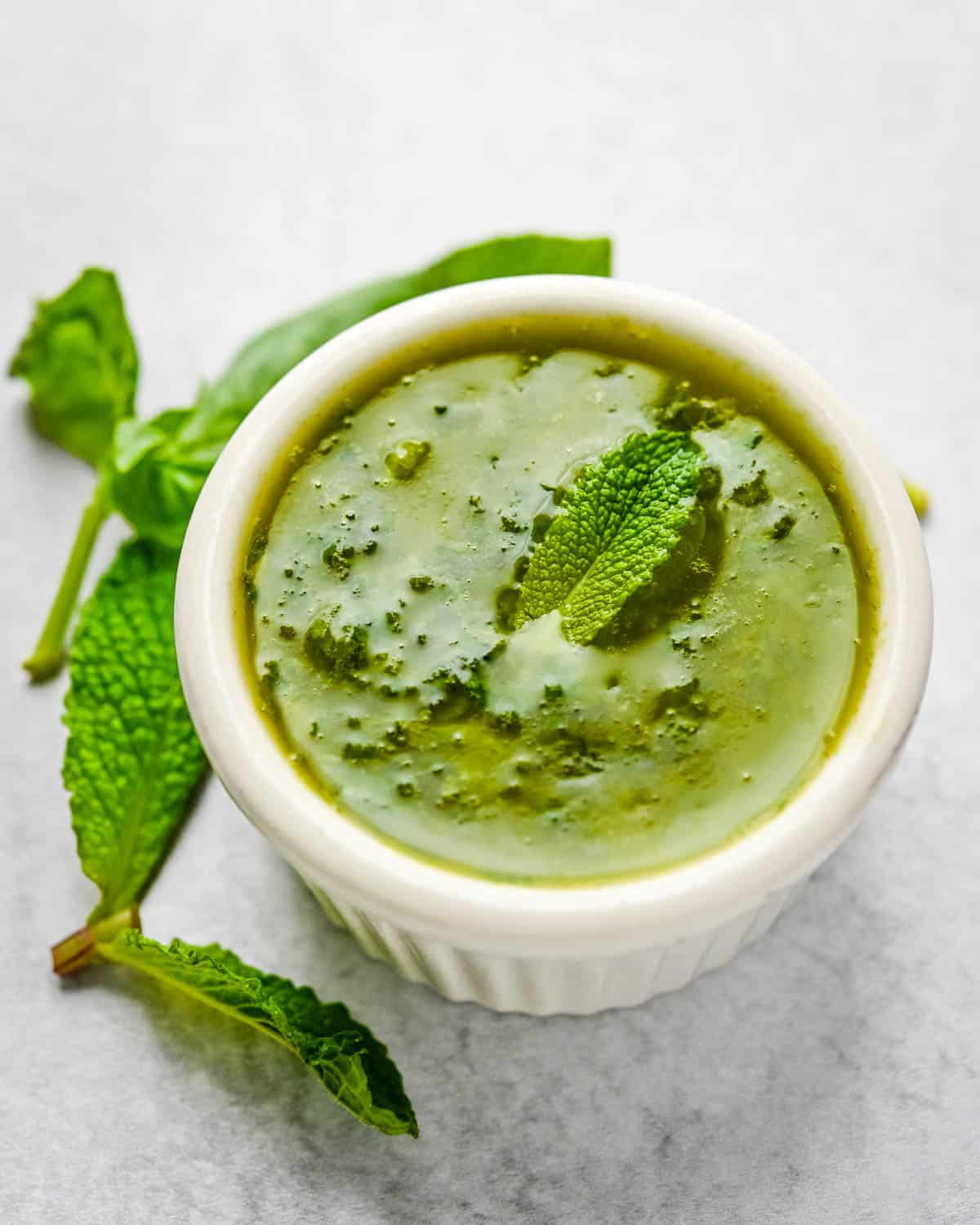 The herb dressing with a piece of mint in it.