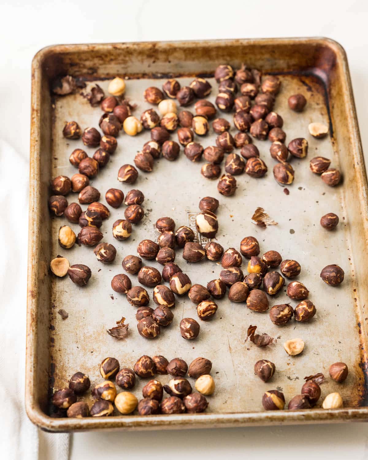 toasted hazelnuts on a baking sheet.