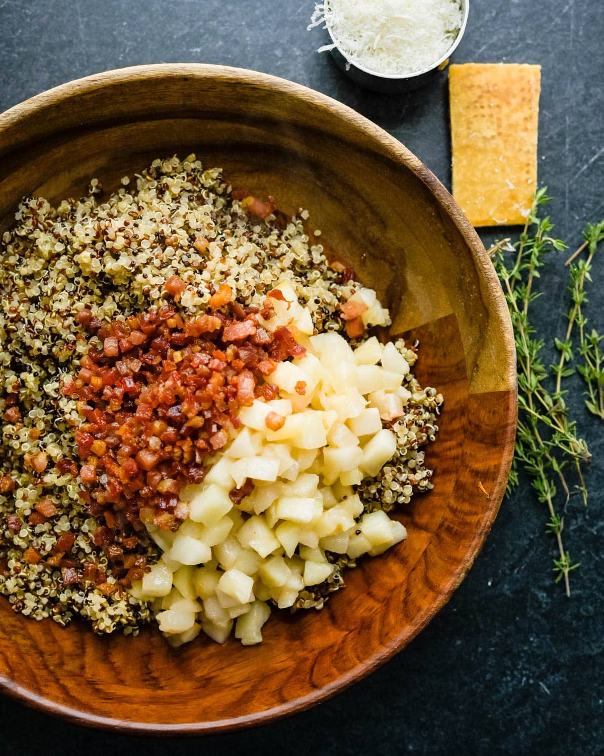 Blending hte apple and pancetta with cooked quinoa.