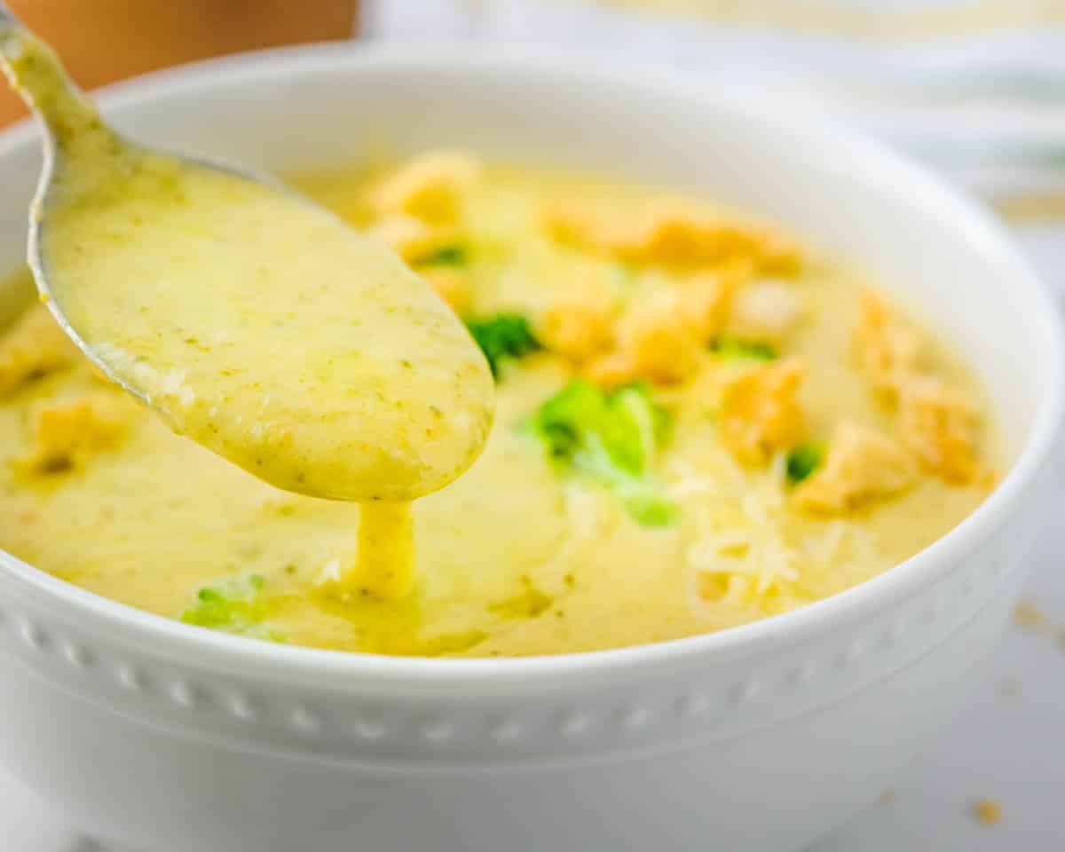 Spooning up some of the creamy, cheesy soup.