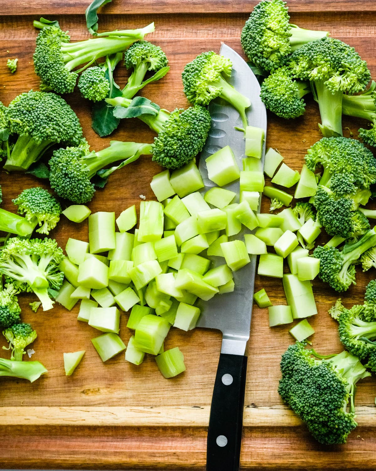 Chopping broccoli florets and stems.