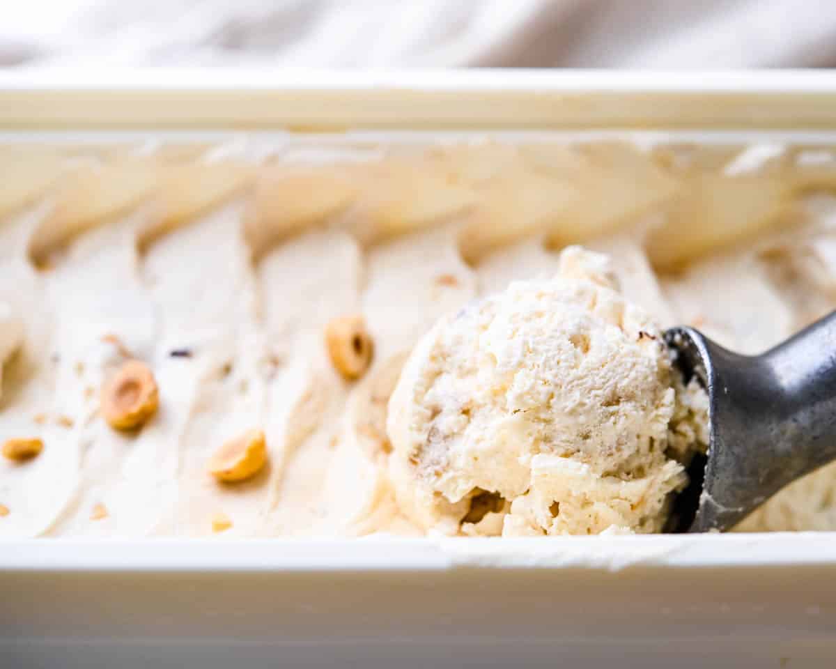 Scooping the Hazelnut nougat ice cream with an ice cream scoop.
