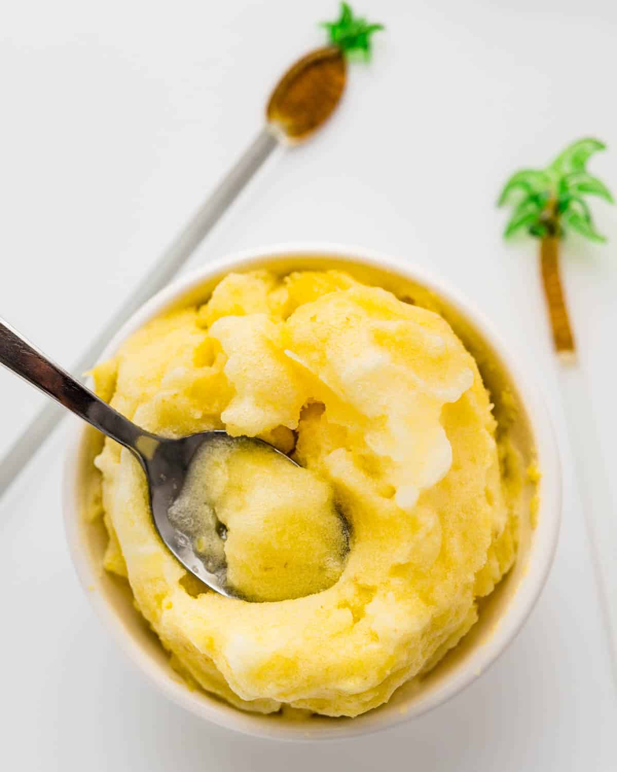 Spooning up the creamy pineapple sorbet from a bowl.