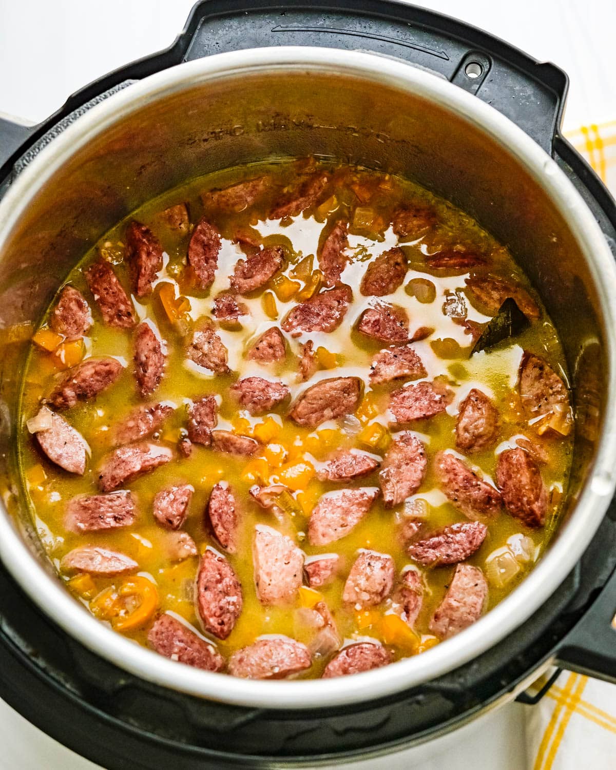 Adding smoked sausage to the instant pot.
