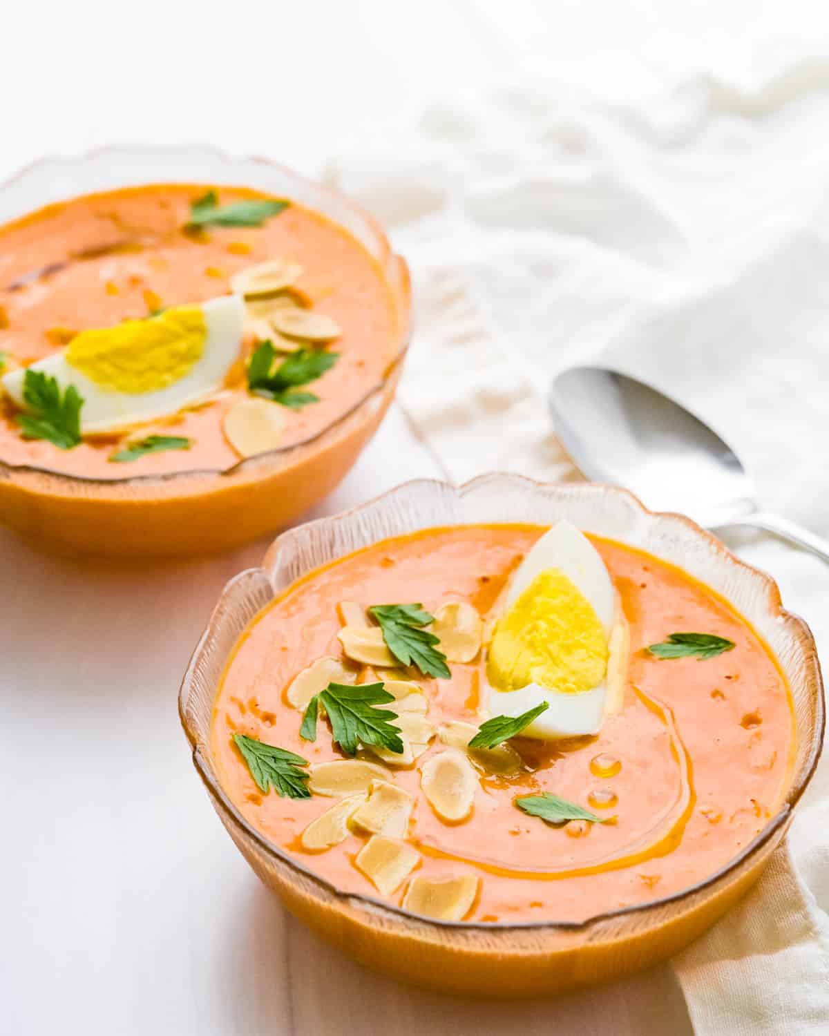 Traditional garnishes for Spanish tomato soup are hard boiled eggs, toasted almonds and a drizzle of oil.
