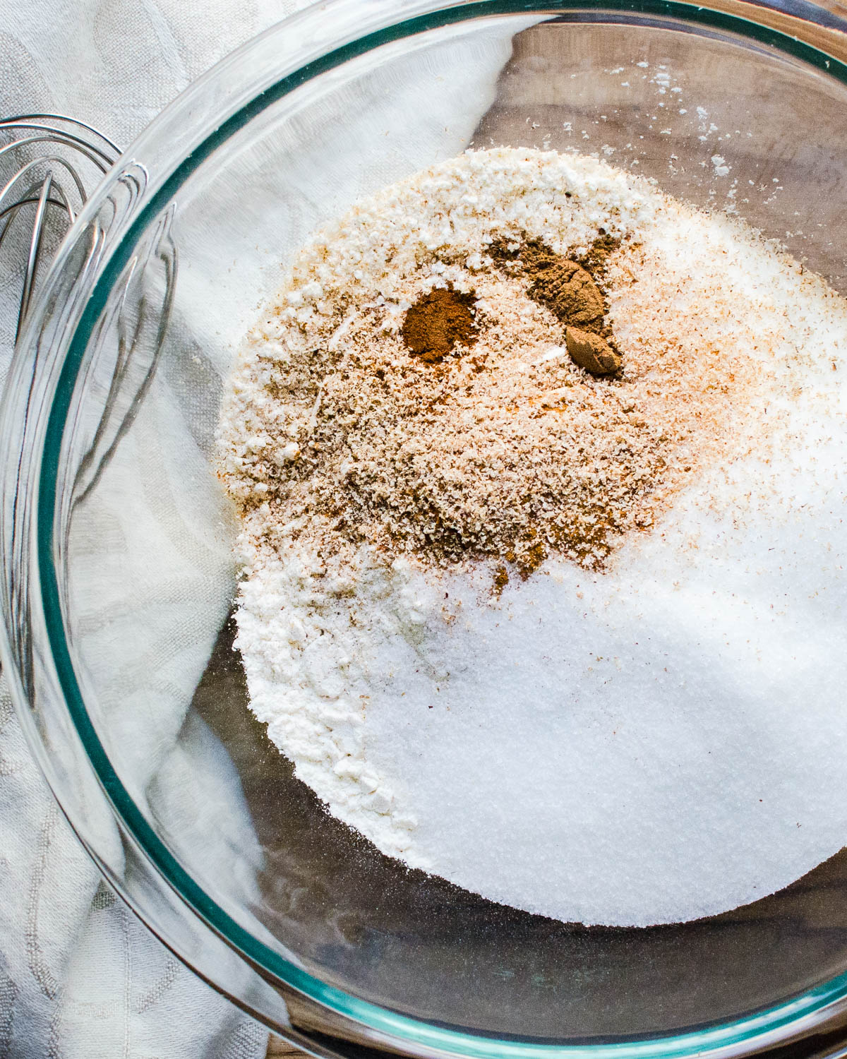 Mixing flour, sugar and spices in a bowl.