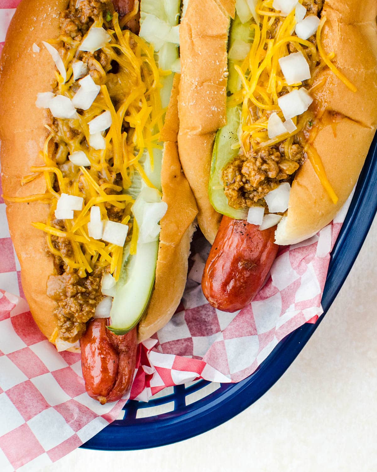 Chili dogs with onions and cheese.