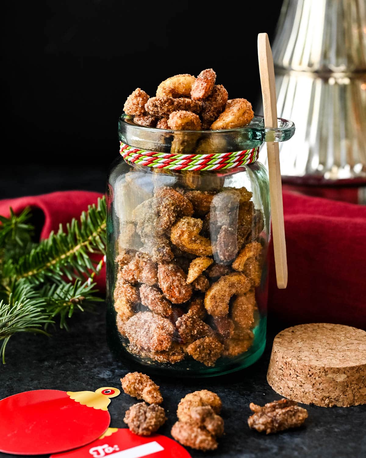 Packaging Christmas spiced nuts in a glass jar to give as a hostess gift.