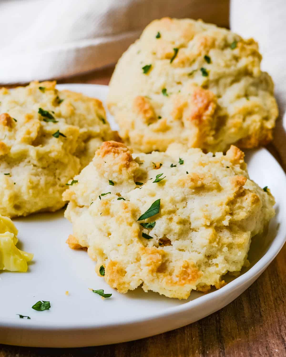 Serving drop biscuits with a pat of butter.