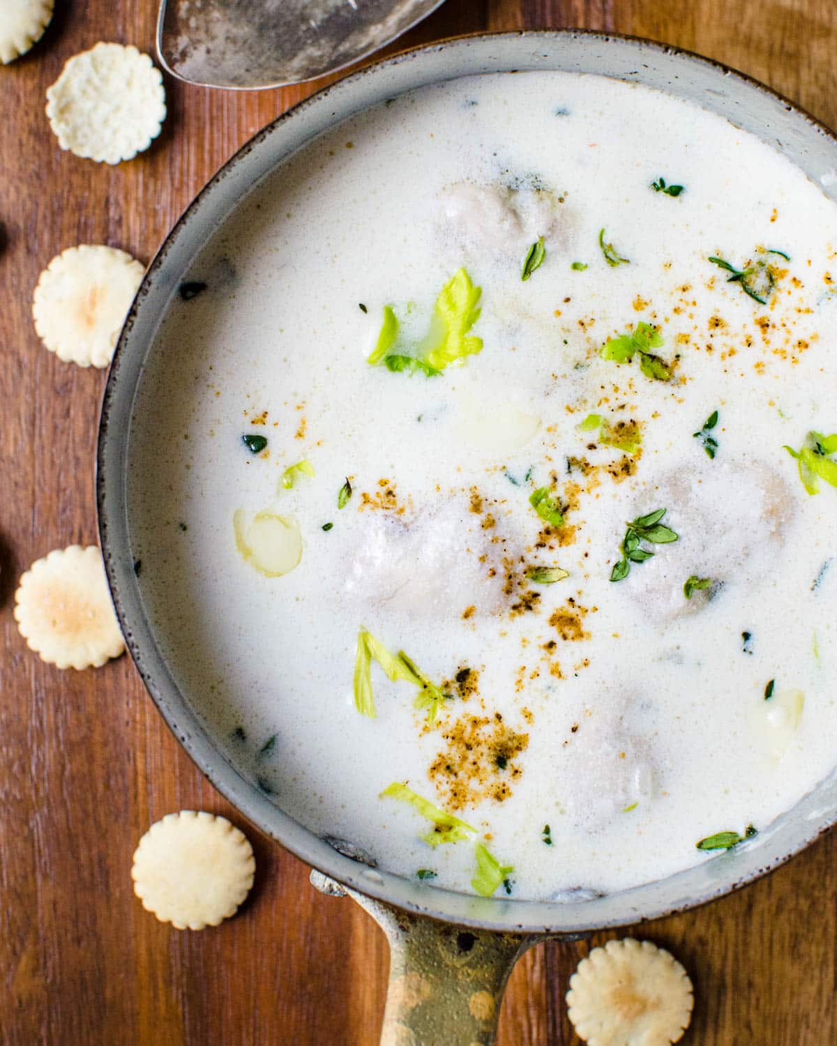 A pot of oyster stew with oyster crackers.