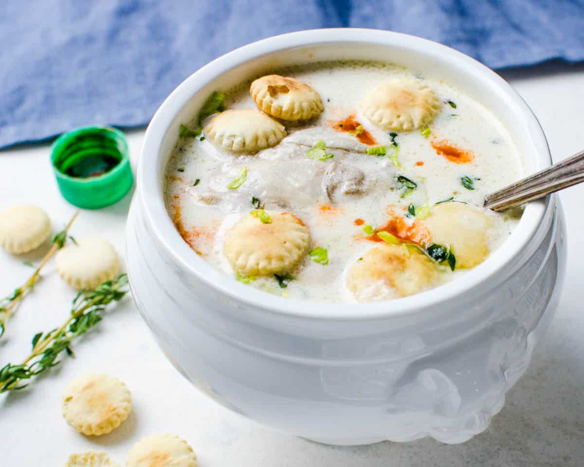 Serve the oyster stew recipe with oyster crackers, celery leaves and hot sauce.