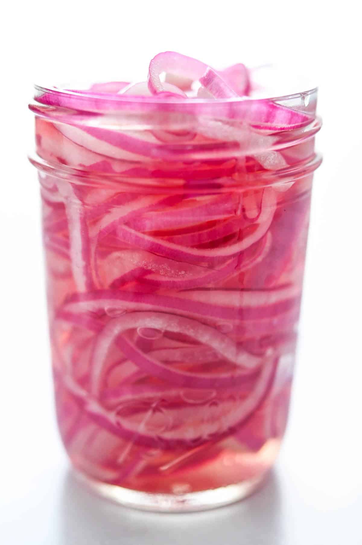 An 8 ounce jar of pickled onions and brine.