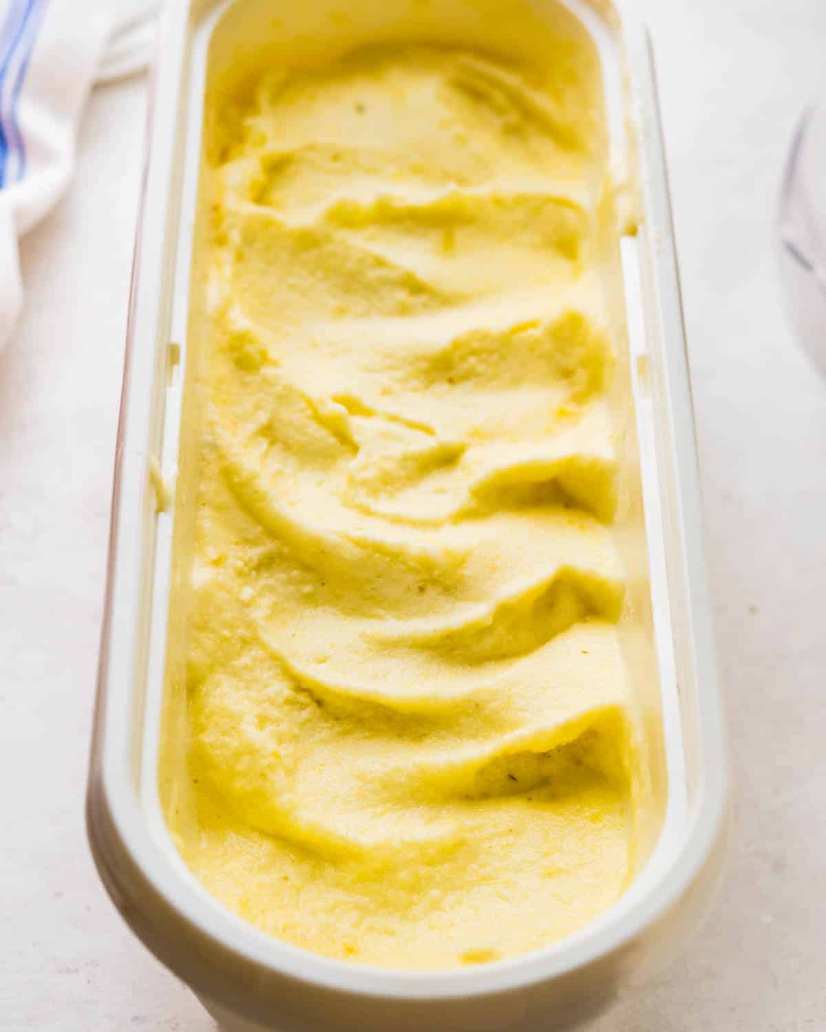 A container filled with homemade pineapple sorbet.