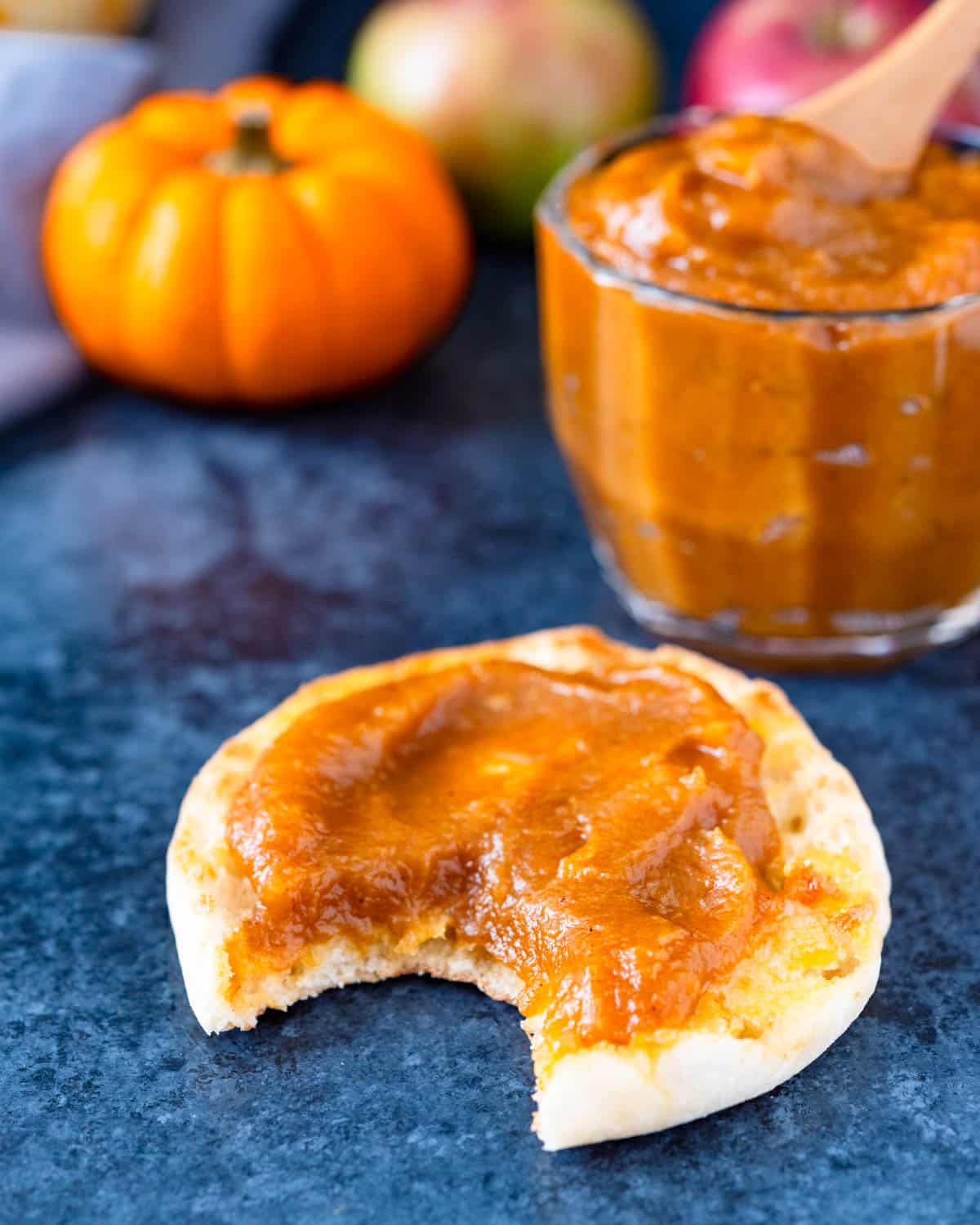 Spreading apple pumpkin butter on an English muffin.