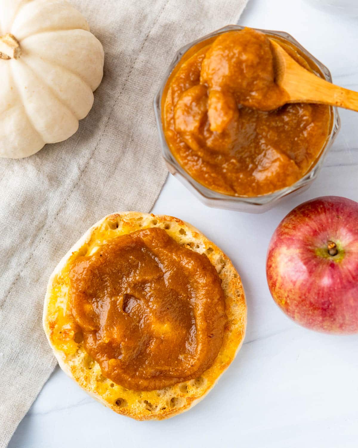 Spreading a muffin with apple pumpkin butter.