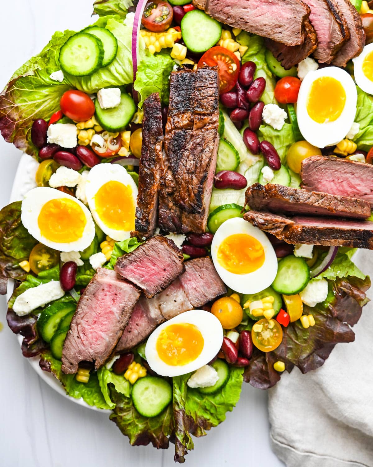 Arranging the steak and jammy eggs on the platter.