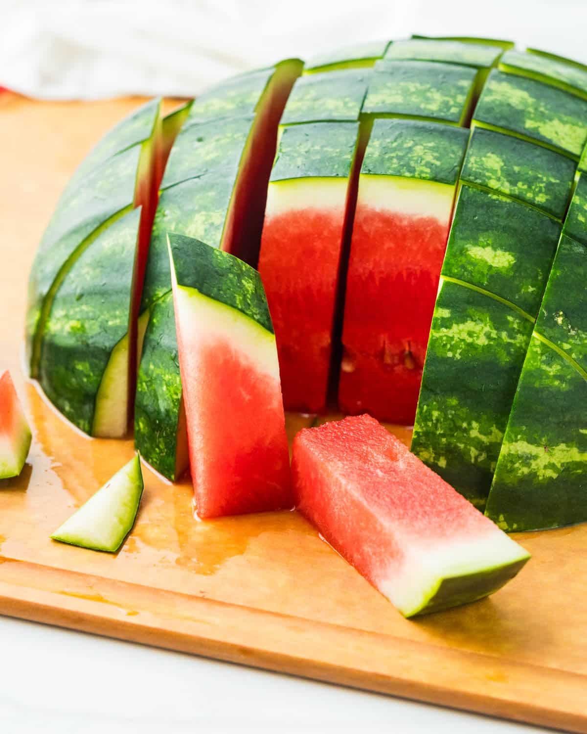 Slicing watermelon into cubes.