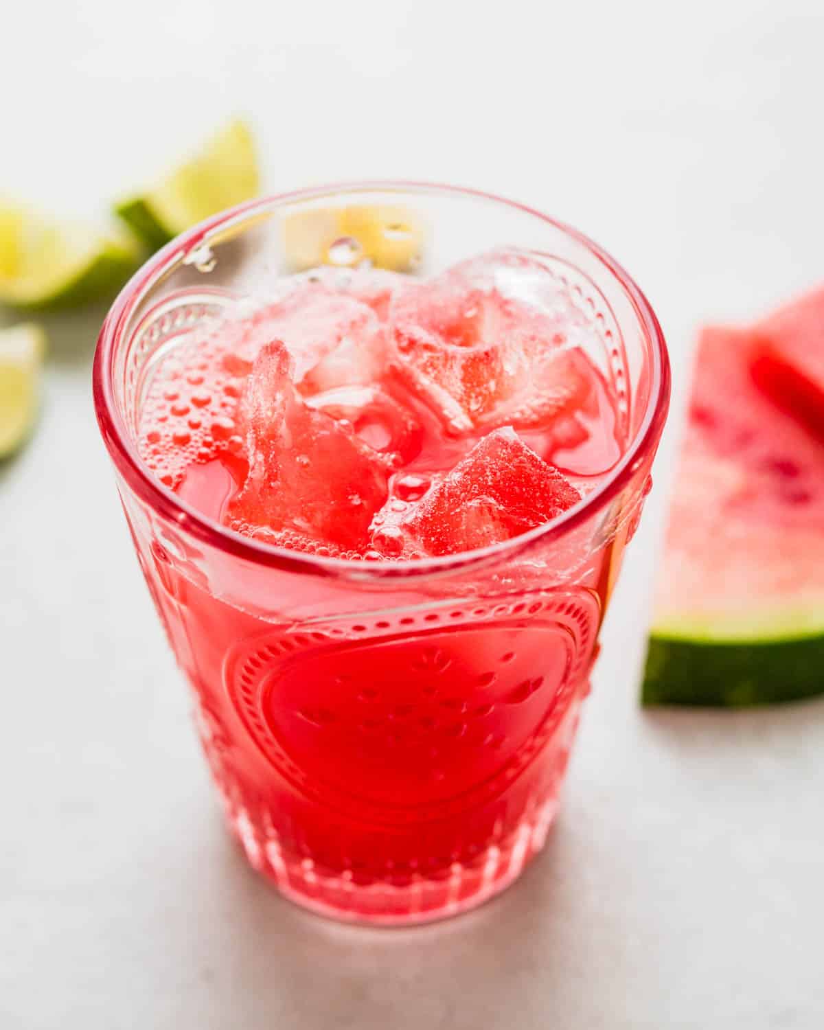 A glass of watermelon water with ice.