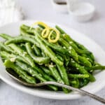 A plate of garlic lemon green beans for serving.