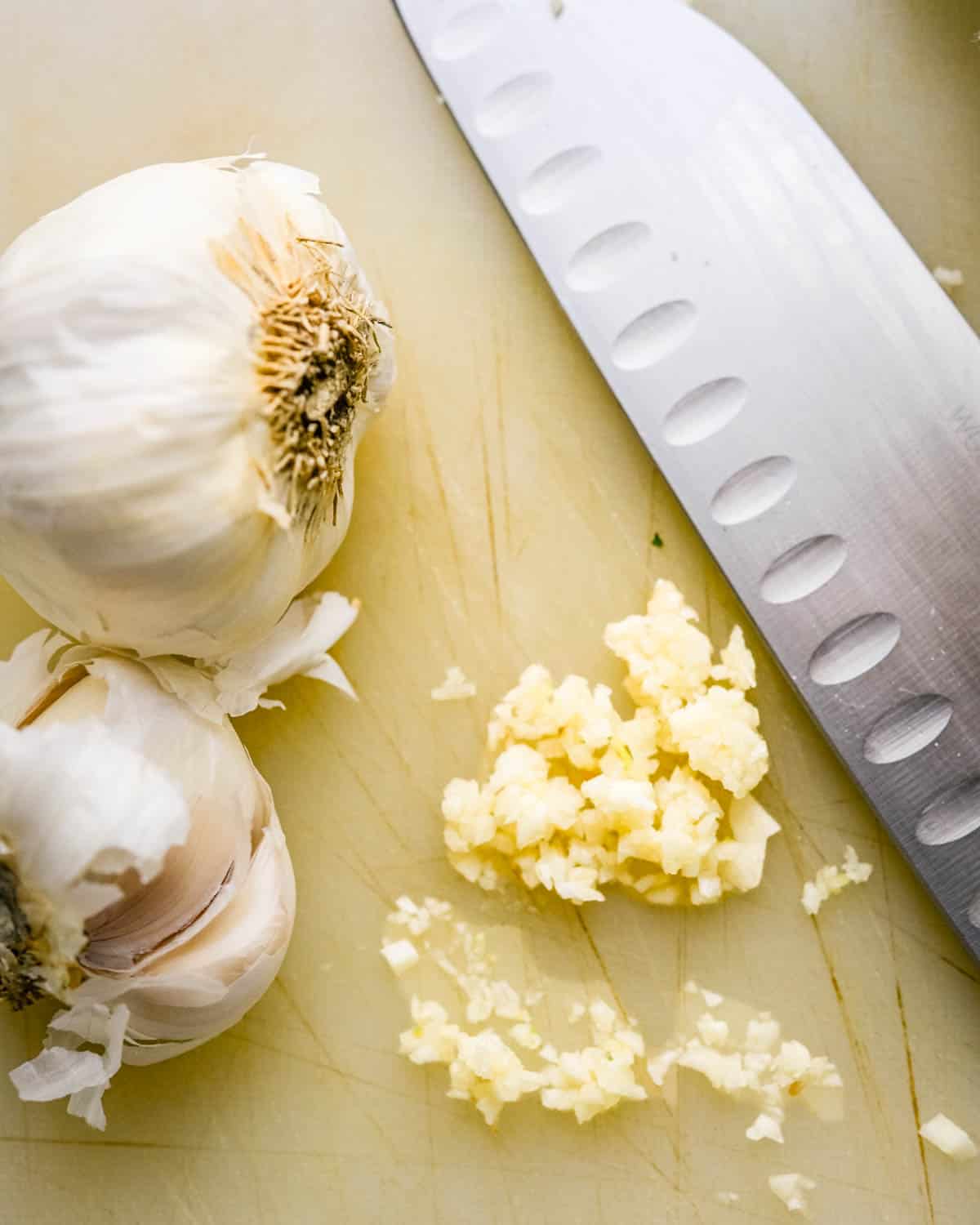 Chopping garlic on a cutting board. 