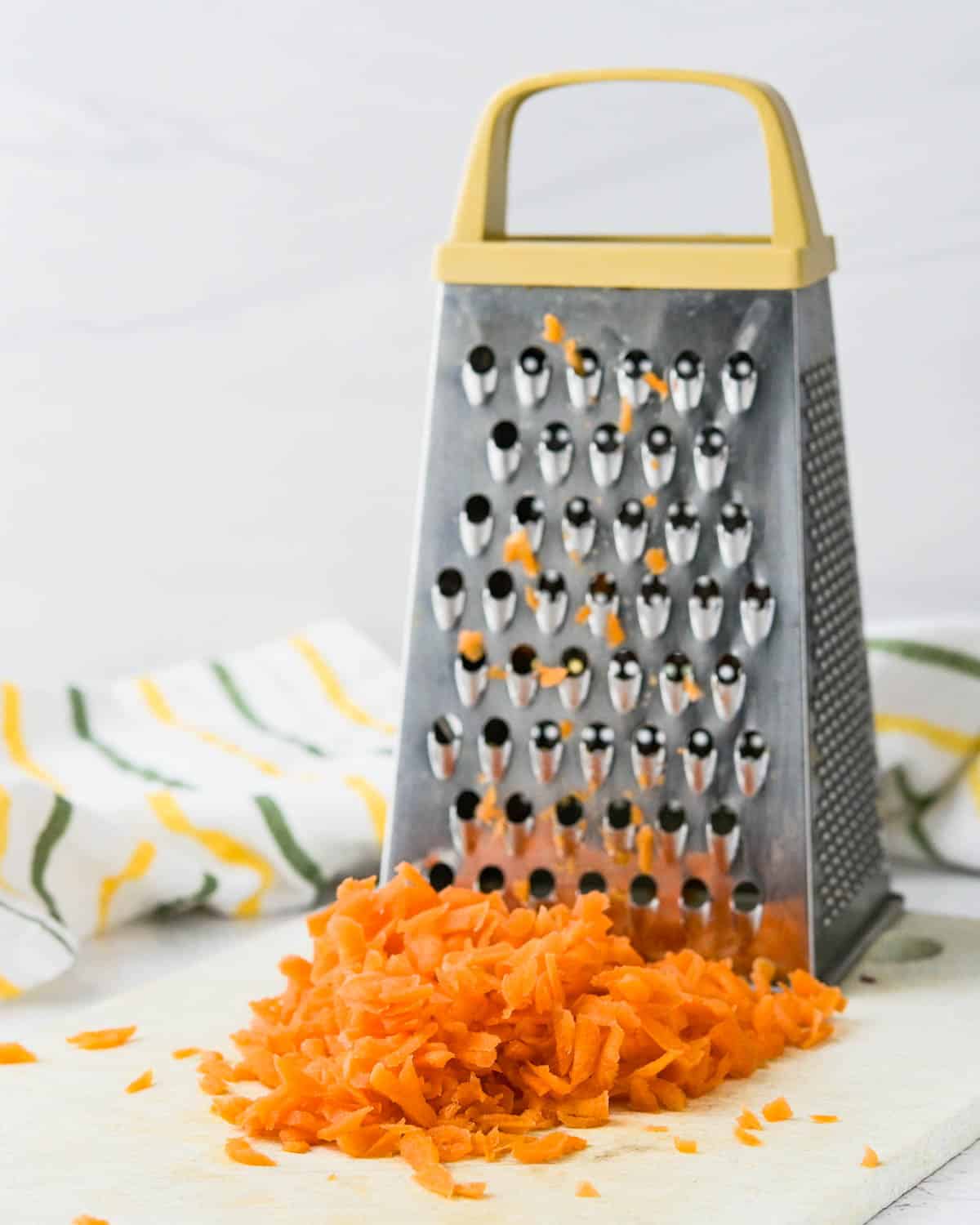grating carrots on a box grater.