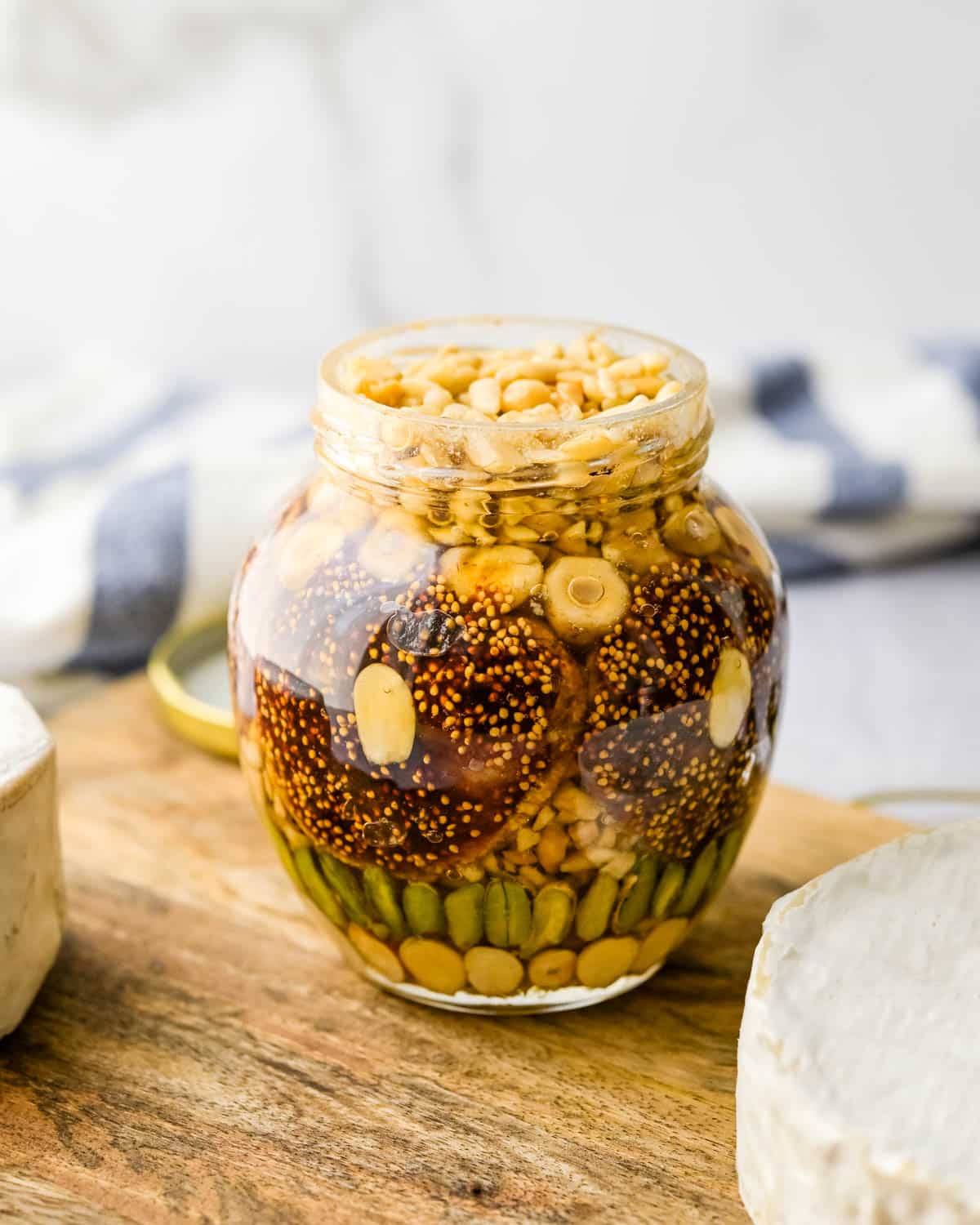 Fruit and nuts in syrup in a pretty jar.