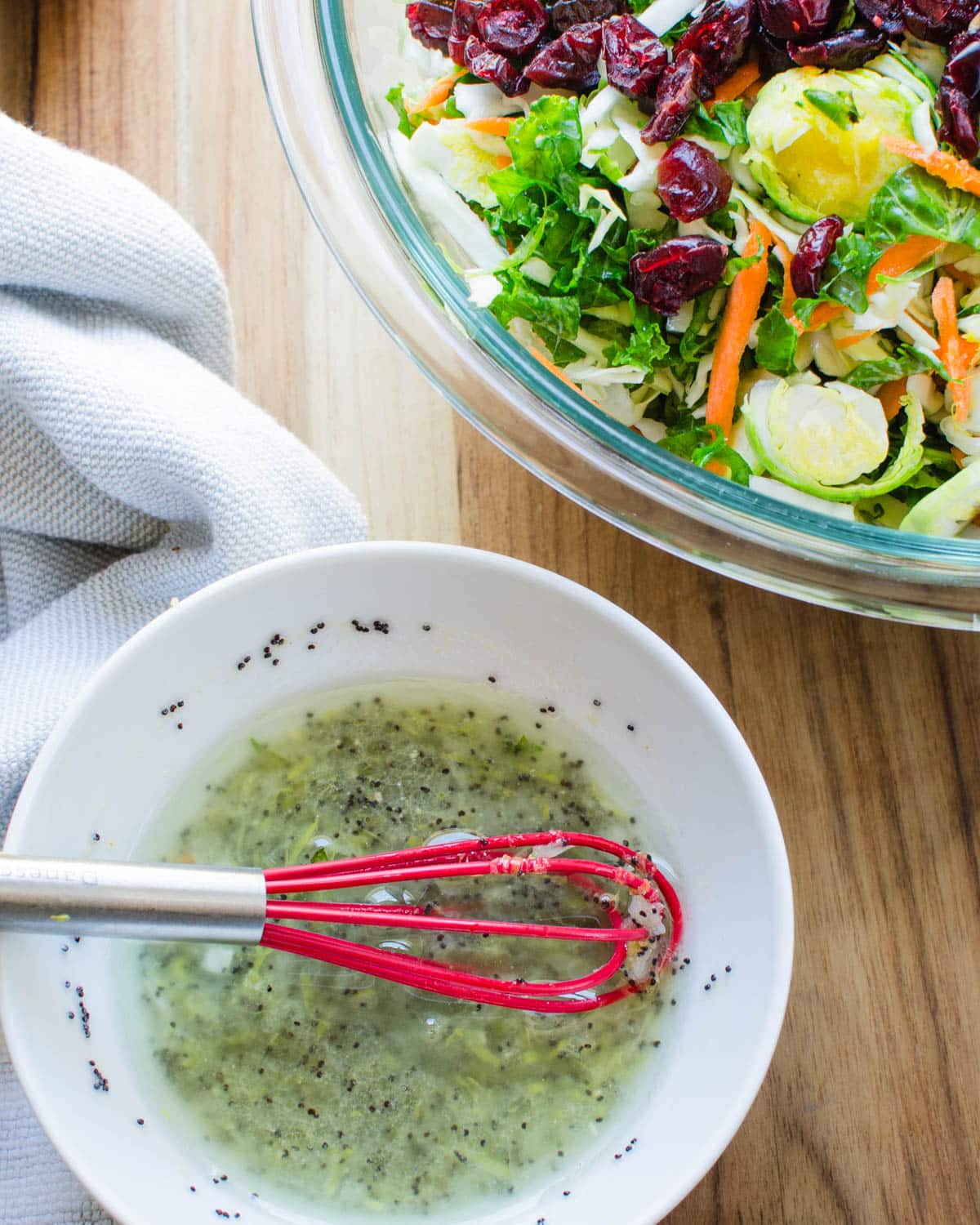 Whisking the poppyseed dressing in a bowl to add to the cabbage salad.