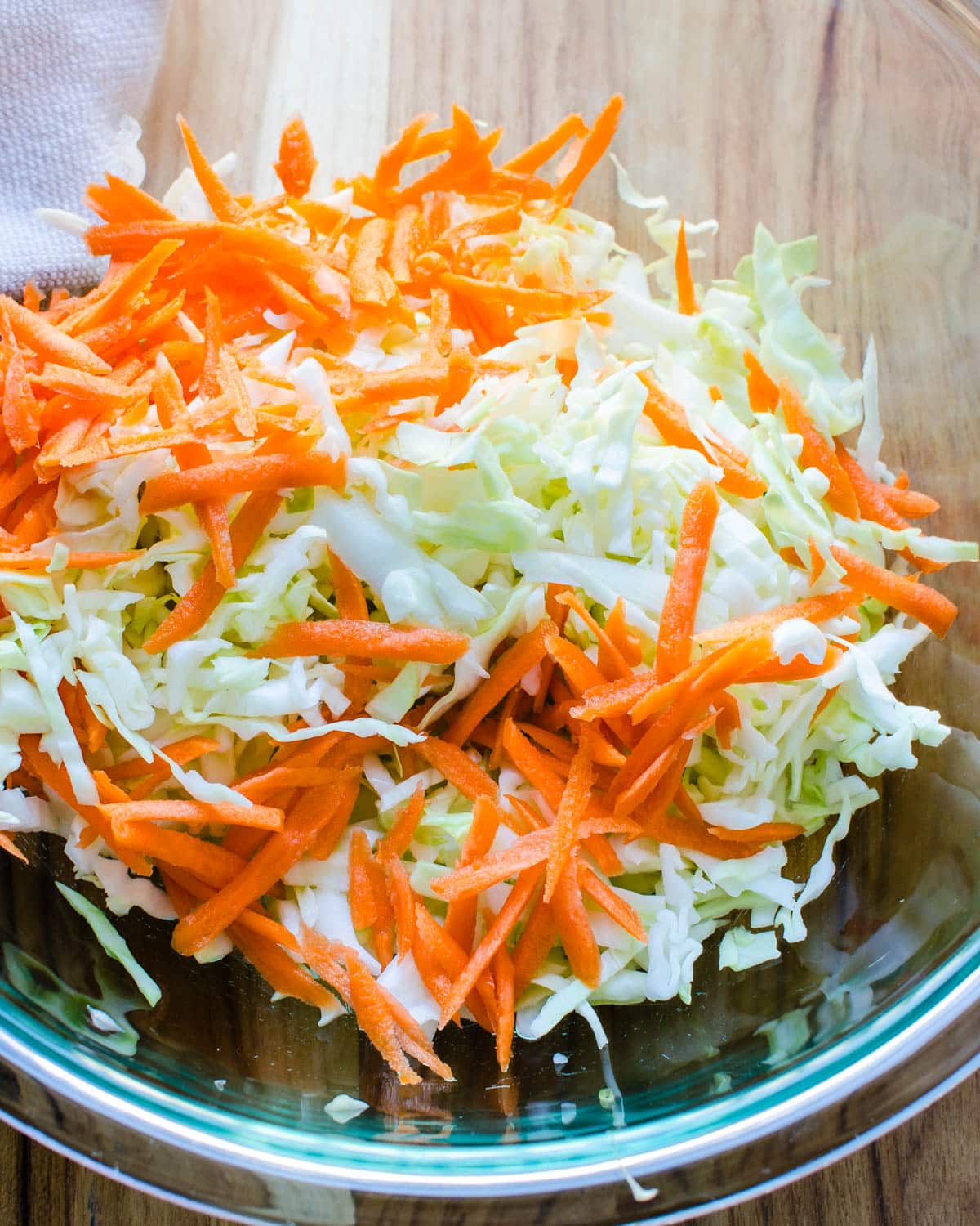 Grated cabbage and carrots in a bowl.