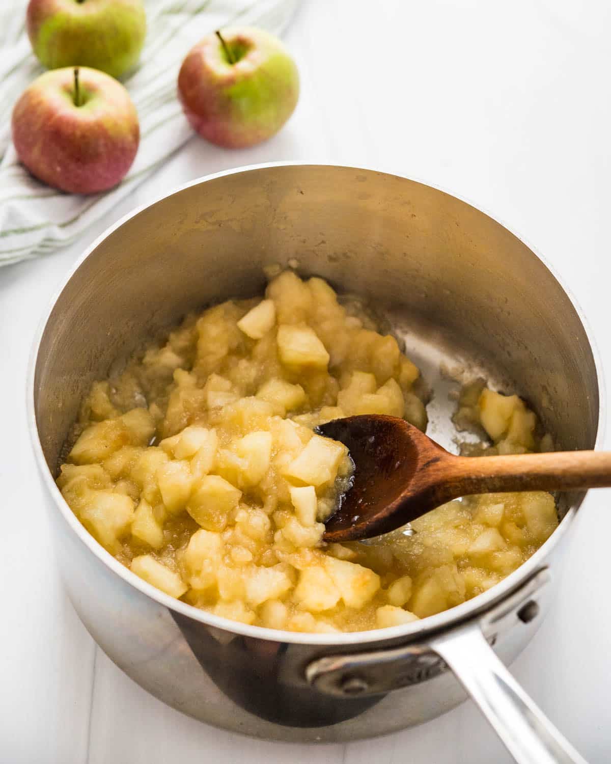 Cooking the apples until they start to fall apart. 