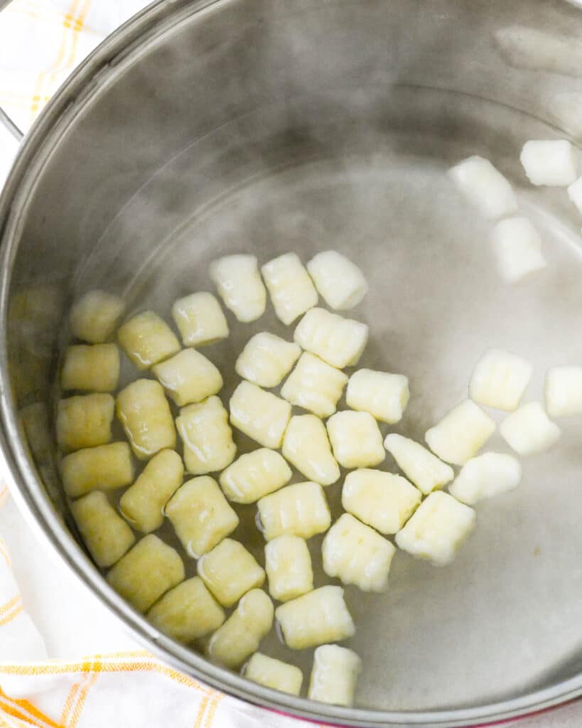 Blanching the potato dumplings in boiling water. 