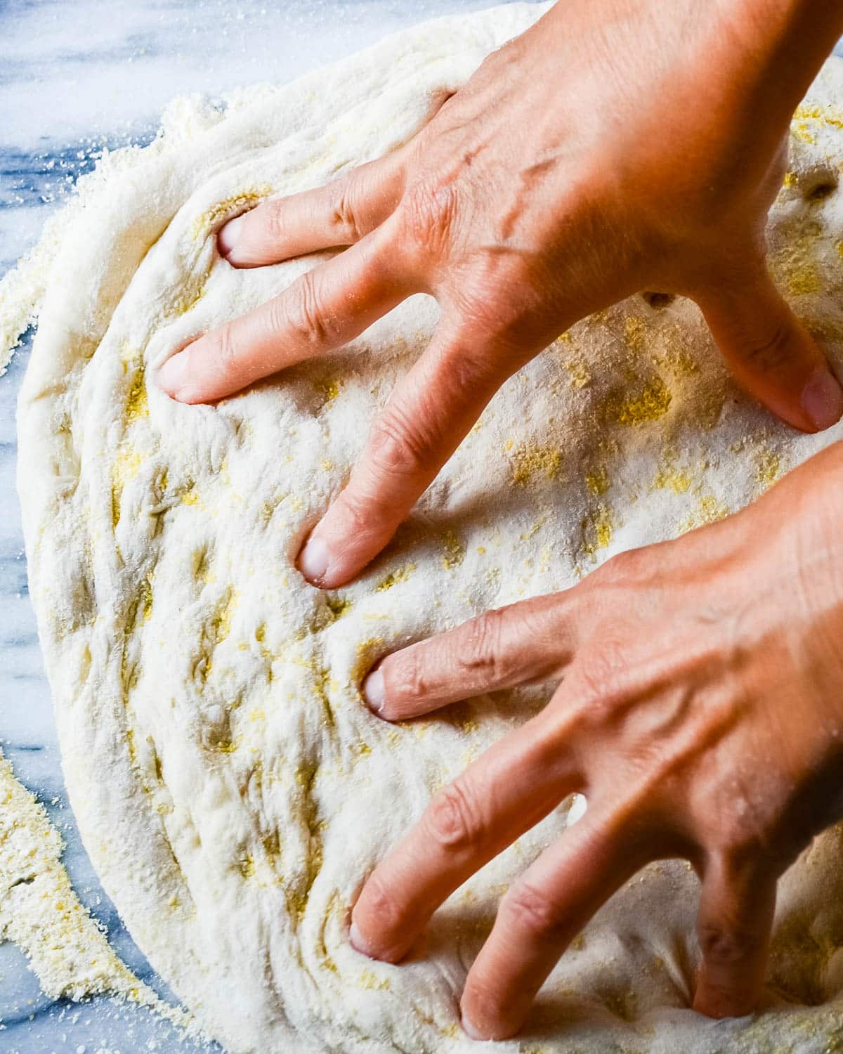 Spreading the dough between my fingers.