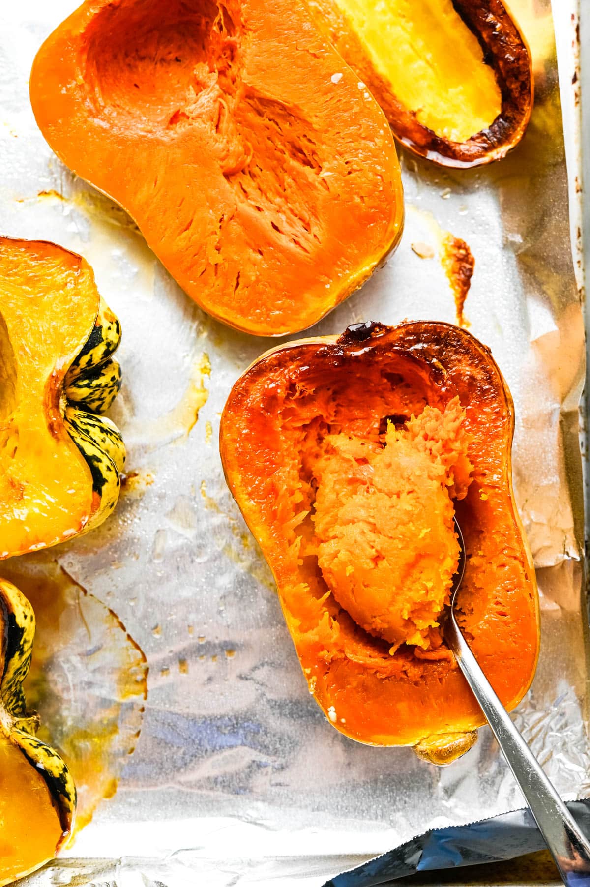 Scooping flesh from the roasted squash.