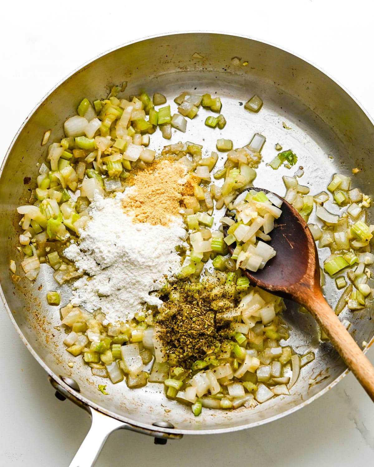 sweating onions, celery and garlic in a skillet and adding flour, dry mustard and oregano.