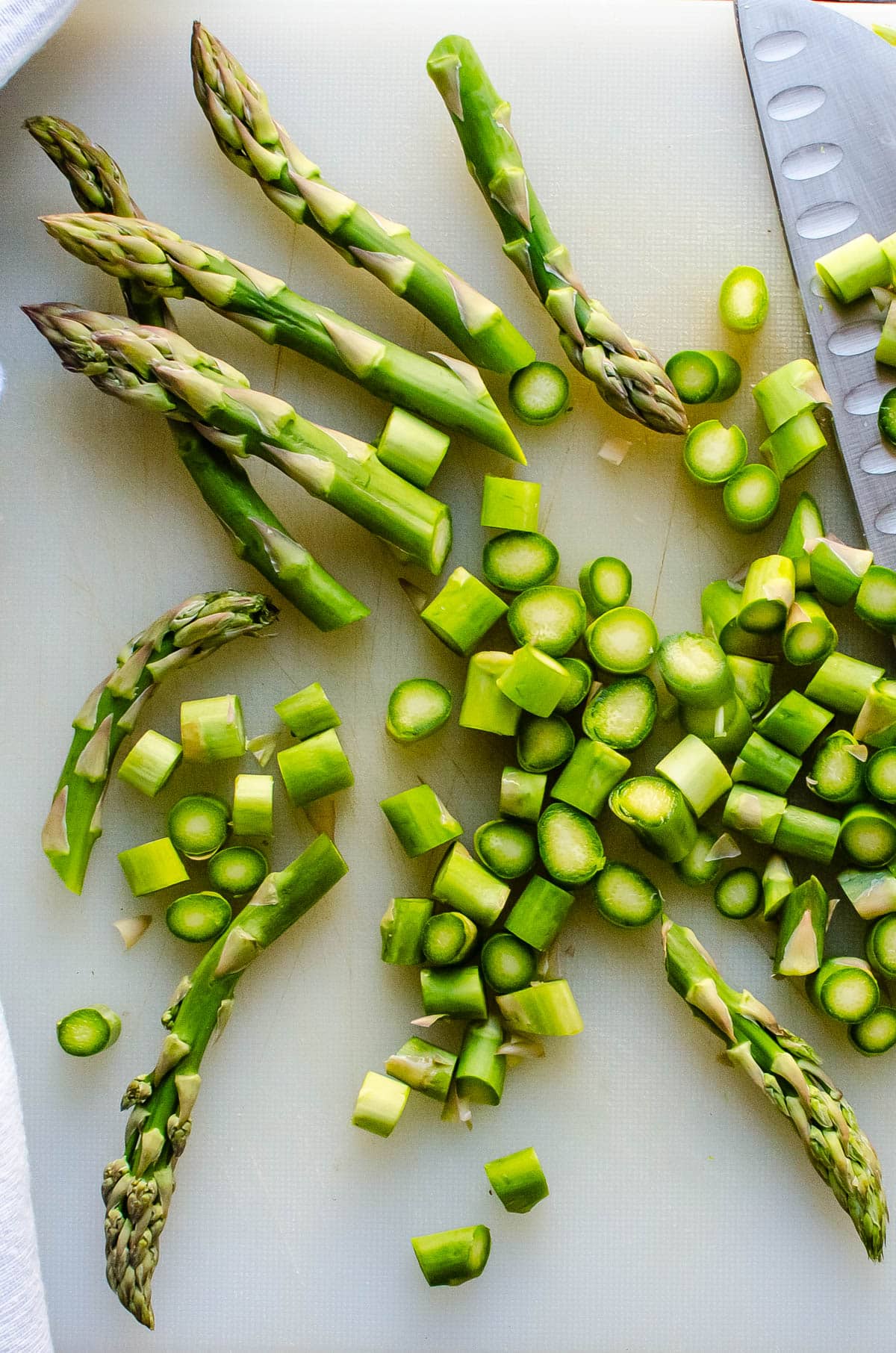 Chopping fresh asparagus spears to blanche.