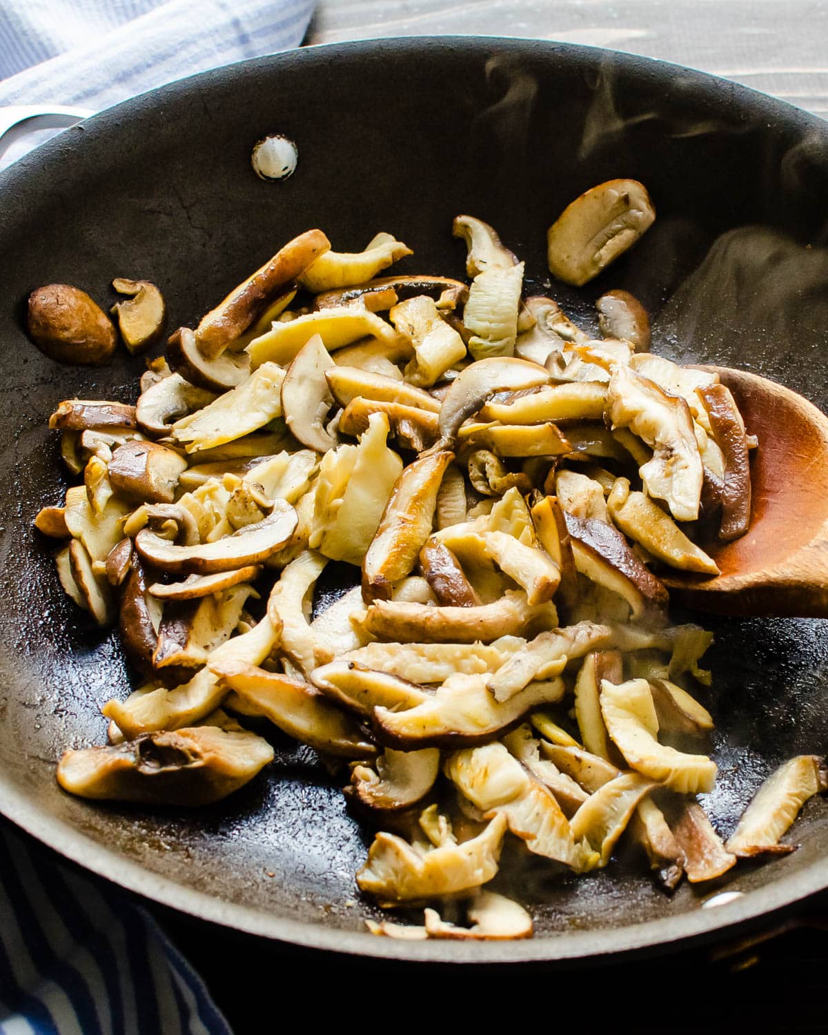 sauteeing mushrooms in a skillet.