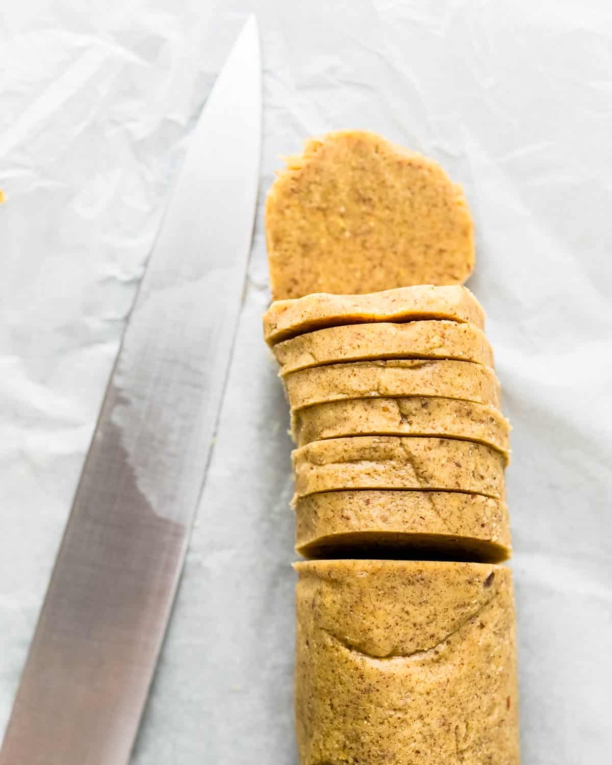 Use a thin, sharp knife to slice the chilled log of dough into rounds. 