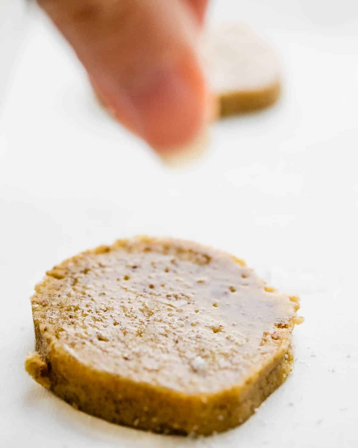 Brush the cookies with an egg white wash and sprinkle on sea