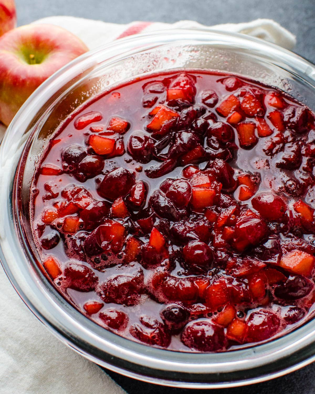 Chilling the cranberry apple sauce in a bowl to firm up and gel.