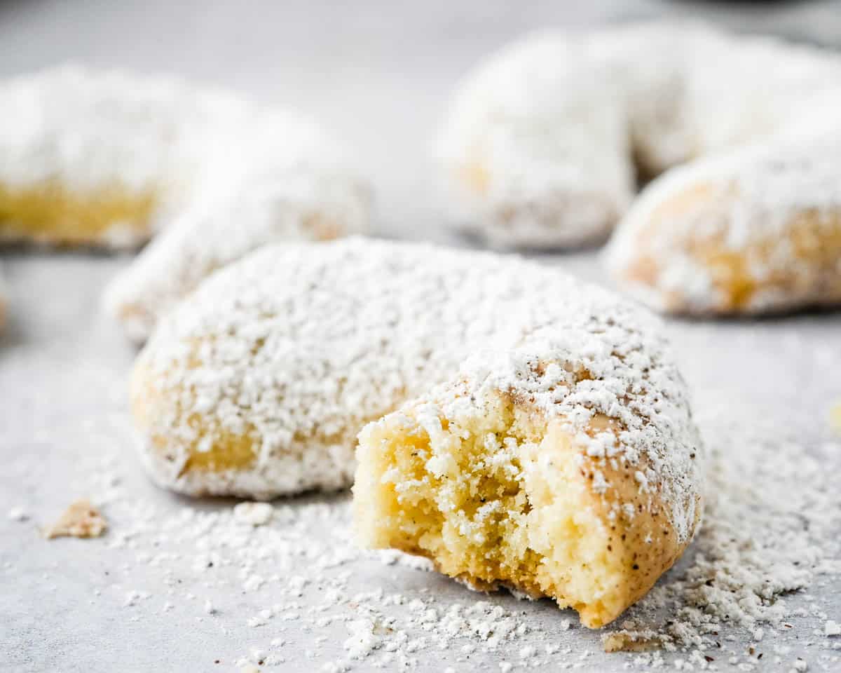 Taking a bite of the almond crescent cookies. 